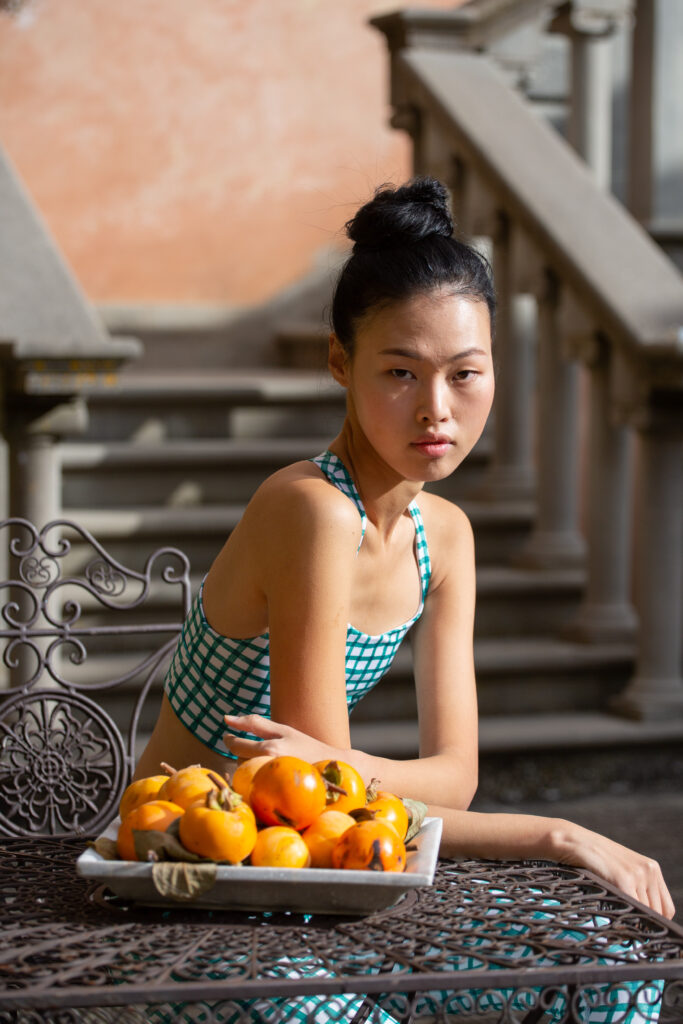 high end outdoor fashion editorial of model in geometric activewear at a tuscan villa