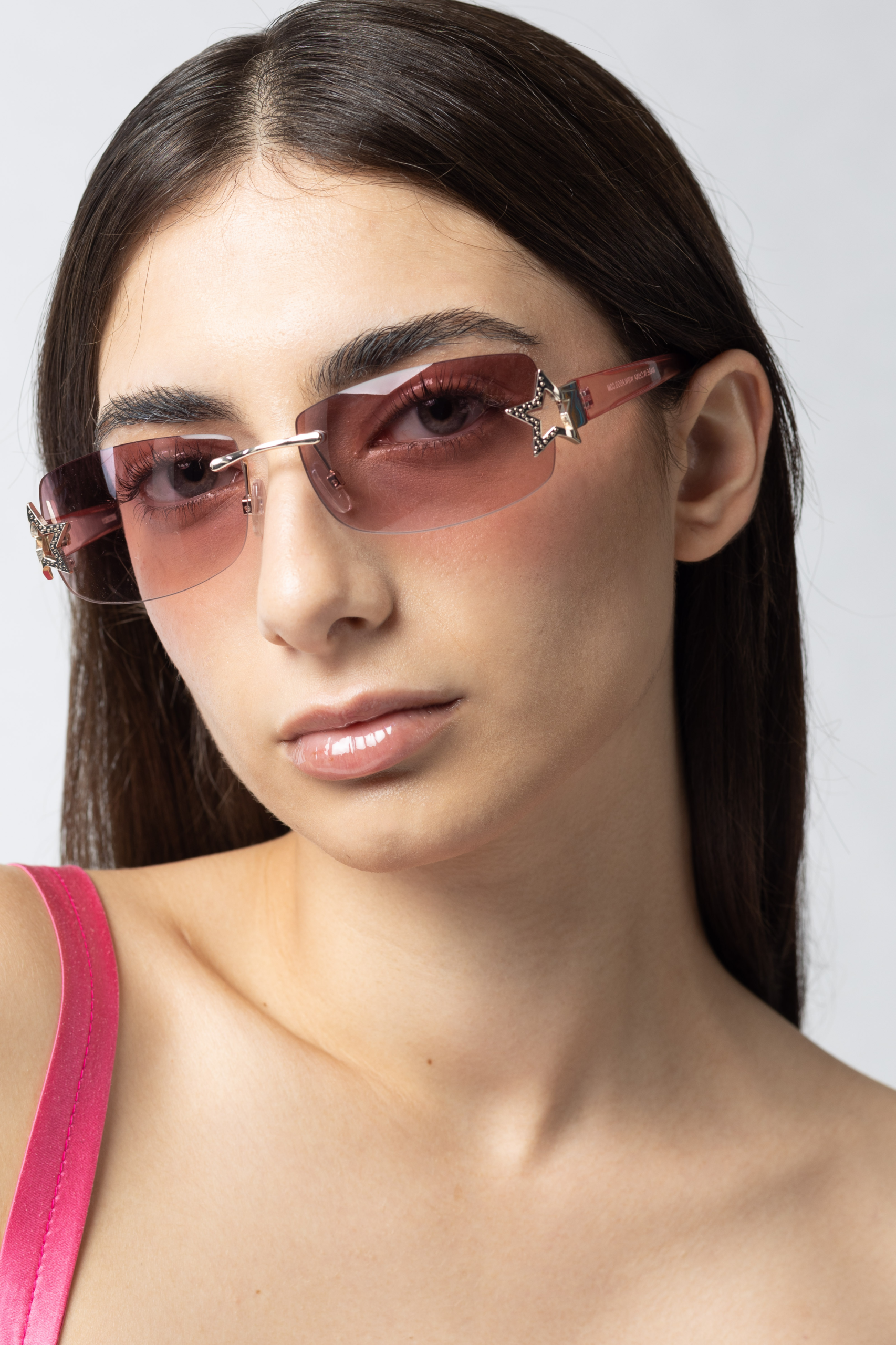 beauty shot detail of natural make up with glossy lips and pink sunglasses